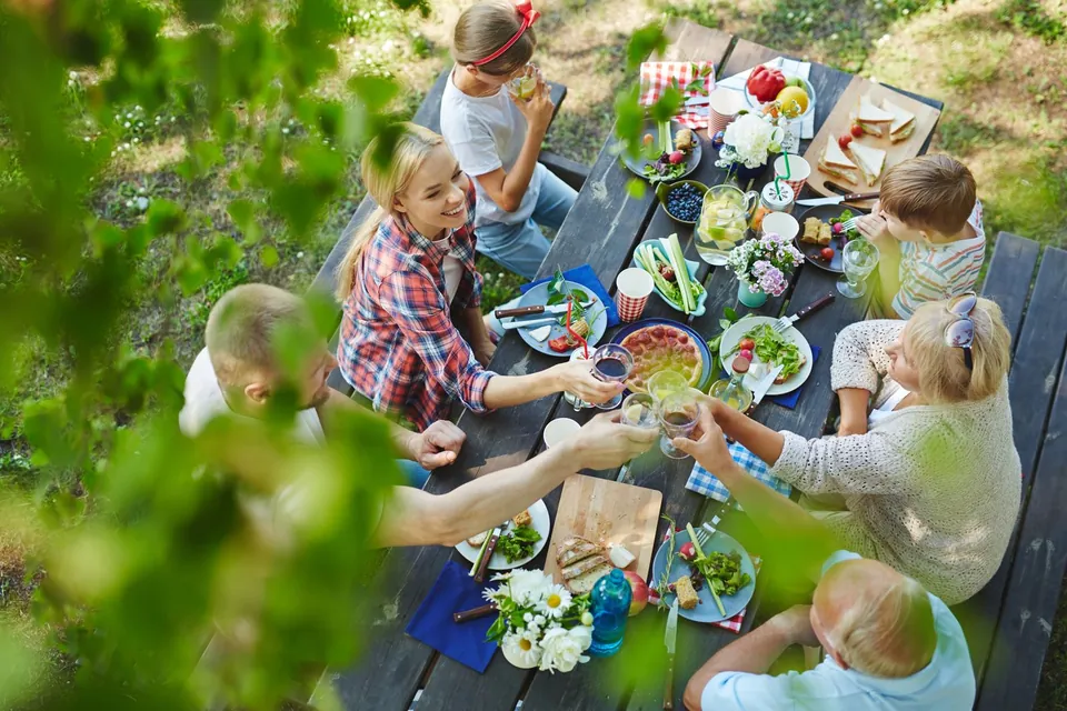 People sharing a meal at an outdoor table