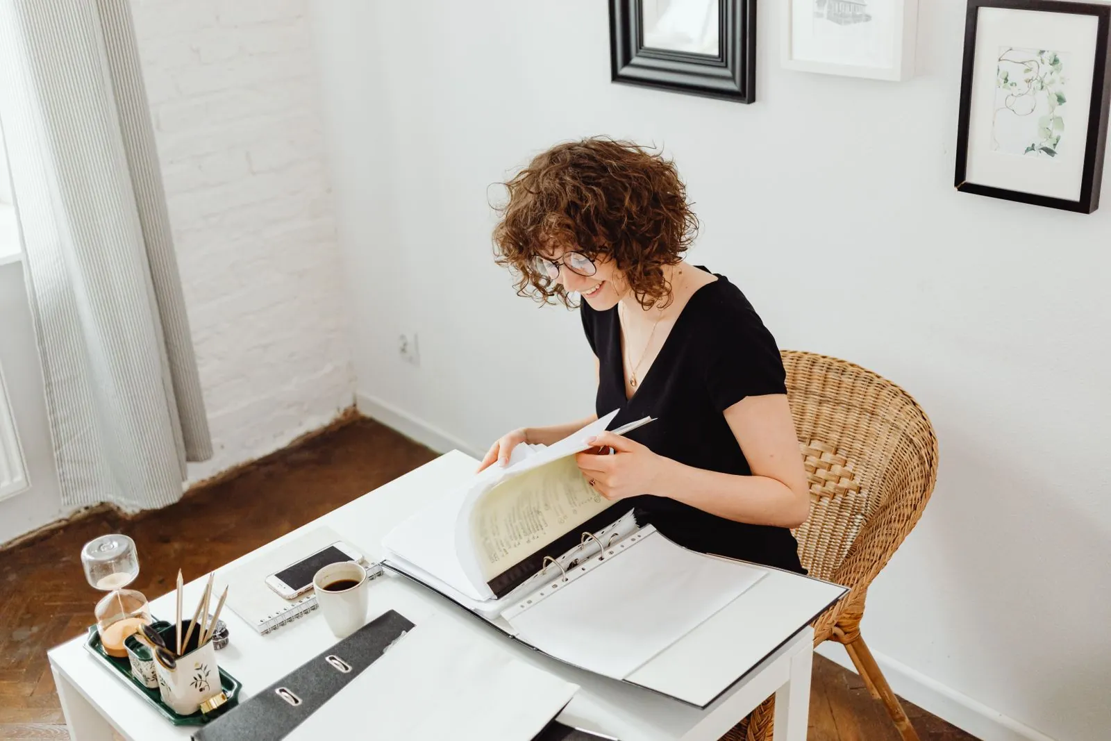 A woman reading paperwork at a table