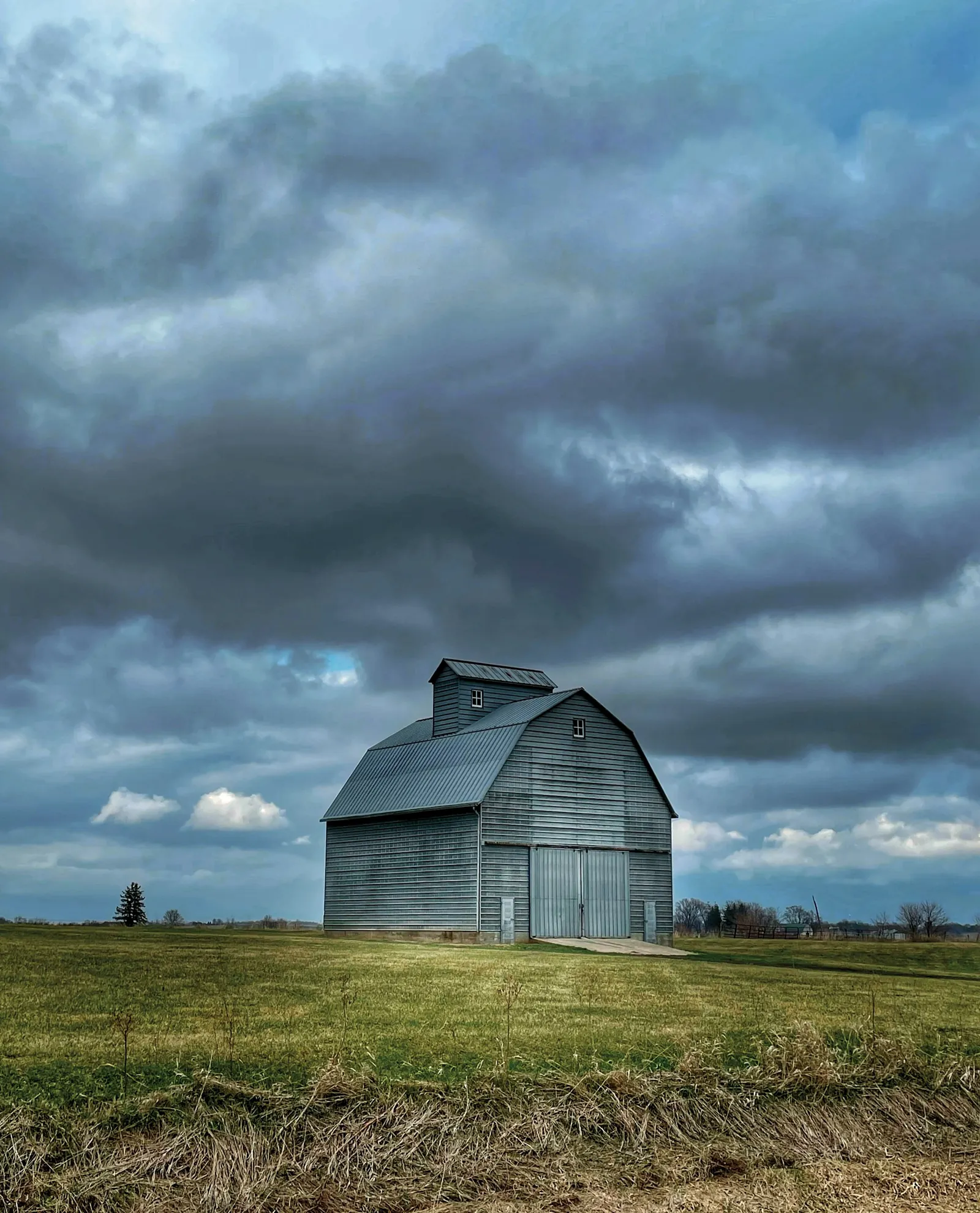 A gray barn beneath clouds in Johnson County, Iowa